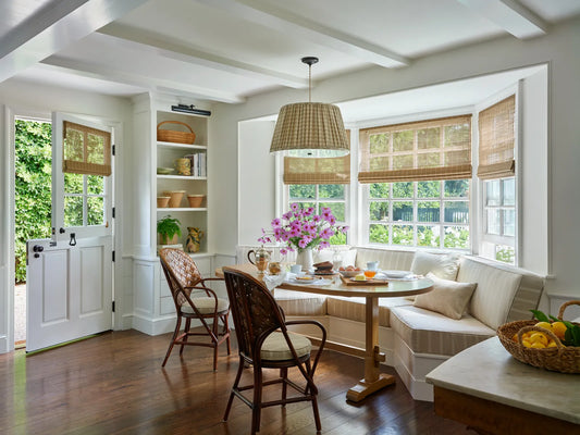 Warm, layered kitchen interior with natural materials and soft lighting in the Nancy Meyers style
